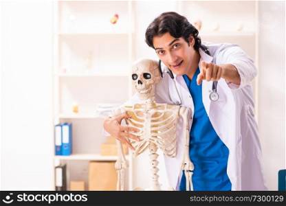 Young male doctor with skeleton 