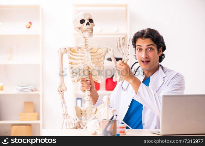 Young male doctor with skeleton 