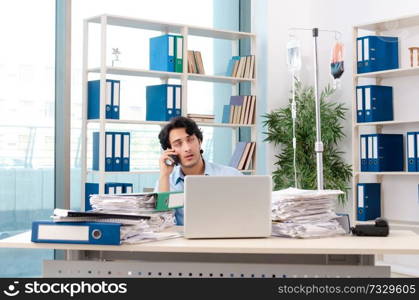 Young male employee in blood transfusion concept