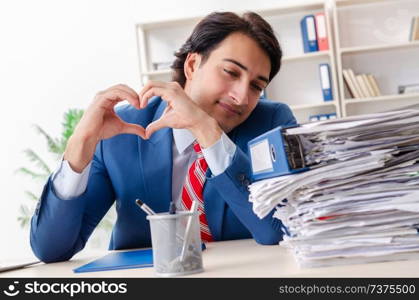 Young male employee in funny workaholic concept 