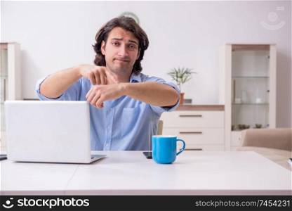 Young male employee working at home 