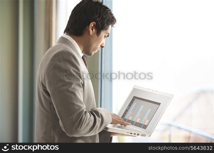 Young male executive using laptop for business purpose