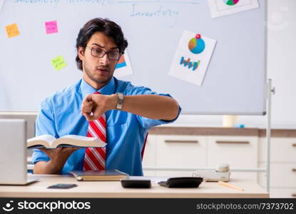 Young male financial manager working in the office 