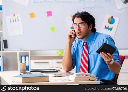 Young male financial manager working in the office 
