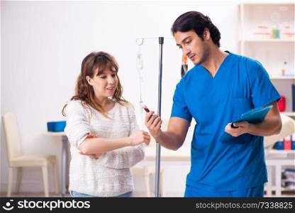 Young male foctor and female patient in blood transfusion concept . Young male foctor and female patient in blood transfusion concep