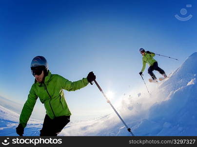 Young male freerider skier moving down in snow powder at sunset; italian alps.