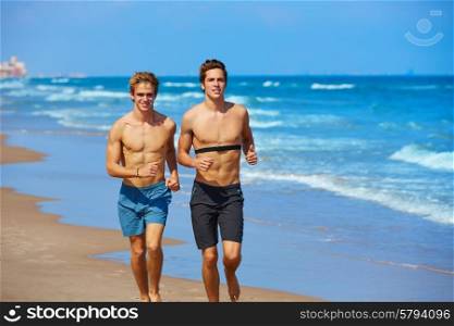 young male friends running in the beach shore in summer vacation