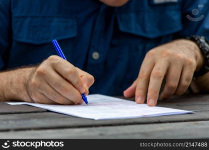 Young male hands filling out forms. Young man writing.