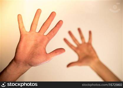 Young male hands making a healing or protecting gesture