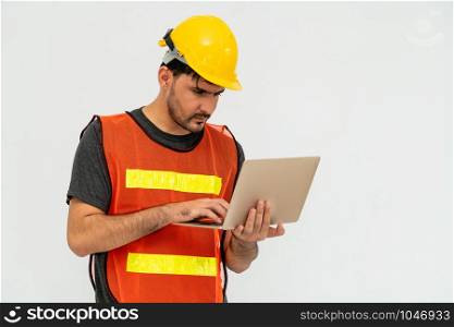 Young male handsome construction worker standing on white background. Civil engineering concept.