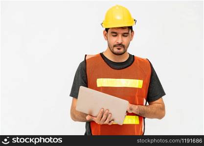 Young male handsome construction worker standing on white background. Civil engineering concept.