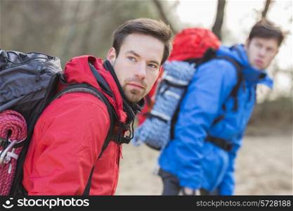 Young male hikers looking away in forest