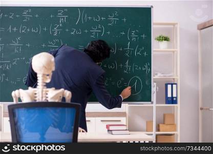 Young male math teacher and student skeleton 