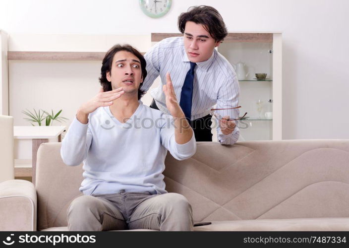 Young male patient discussing with psychologist personal problems . Young male patient discussing with psychologist personal problem