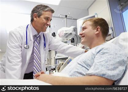 Young Male Patient Talking To Doctor In Emergency Room