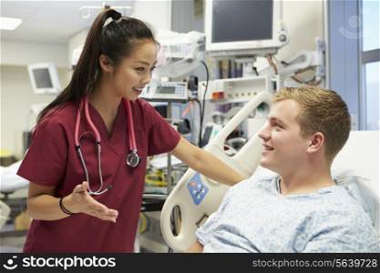 Young Male Patient Talking To Female Nurse In Emergency Room