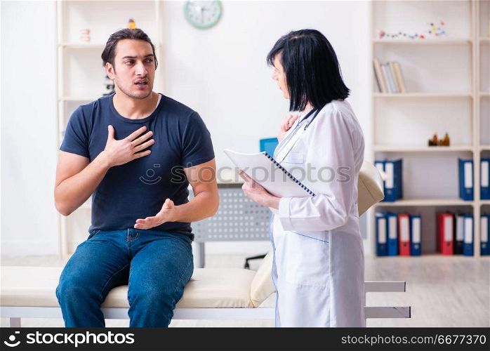 Young male patient visiting aged female doctor 