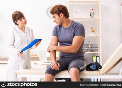 Young male patient visiting female doctor traumatologist . The young male patient visiting female doctor traumatologist 
