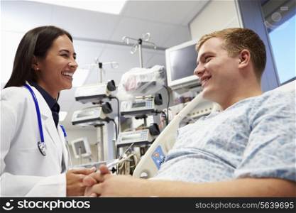 Young Male Patient With Female Doctor In Emergency Room