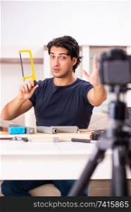 Young male repairman recording video for his blog 
