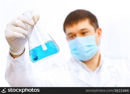 Young male scientist working with liquids in laboratory