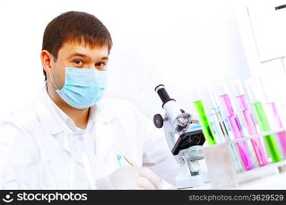 Young male scientist working with liquids in laboratory