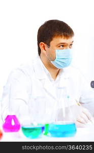 Young male scientist working with liquids in laboratory