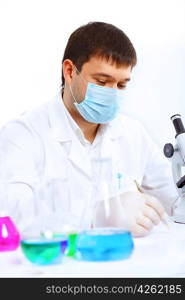 Young male scientist working with liquids in laboratory