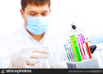 Young male scientist working with liquids in laboratory