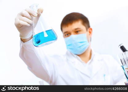 Young male scientist working with liquids in laboratory