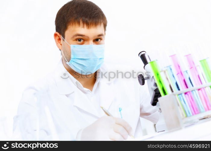 Young male scientist working with liquids in laboratory