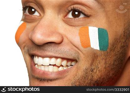 Young Male Sports Fan With Ivory Coast Flag Painted On Face