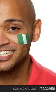 Young Male Sports Fan With Nigerian Flag Painted On Face