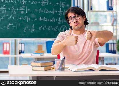 Young male student in the classroom 