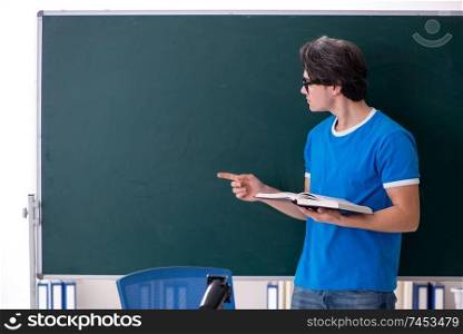Young male student in the classroom 