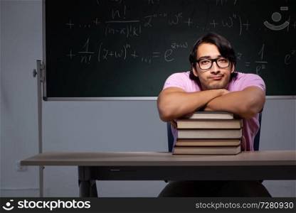 Young male student sitting in classroom