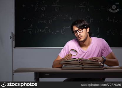 Young male student sitting in classroom