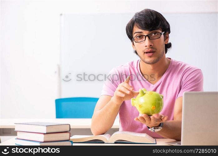Young male student sitting in the class 