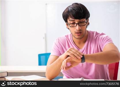 Young male student sitting in the class