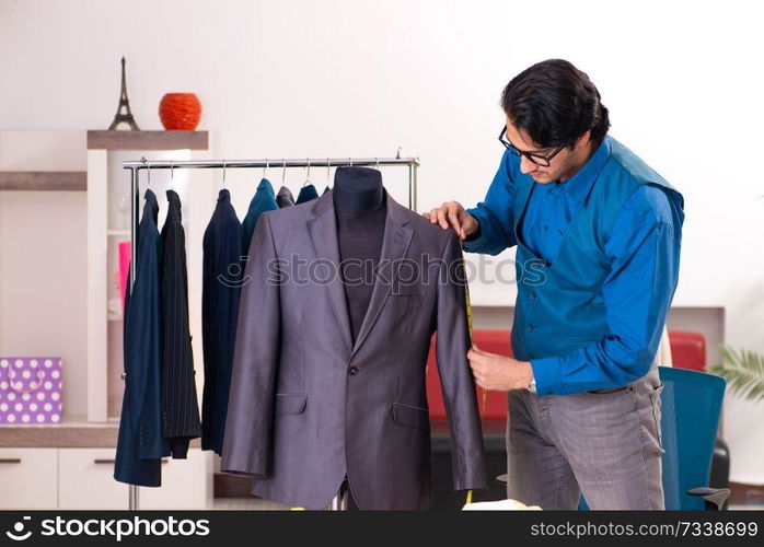 Young male tailor working at workshop 