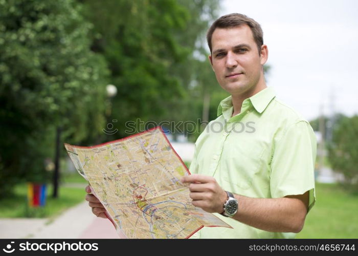 Young male tourist with map in hand good looking. Tourist map of the city of Moscow, Russia (no trademark)