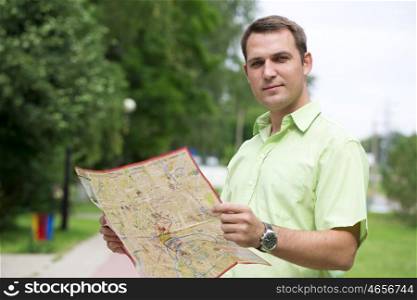 Young male tourist with map in hand good looking. Tourist map of the city of Moscow, Russia (no trademark)