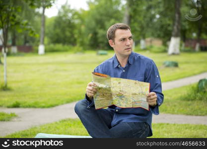 Young male tourist with map in hand looking around. Tourist map of the city of Moscow, Russia (no trademark)