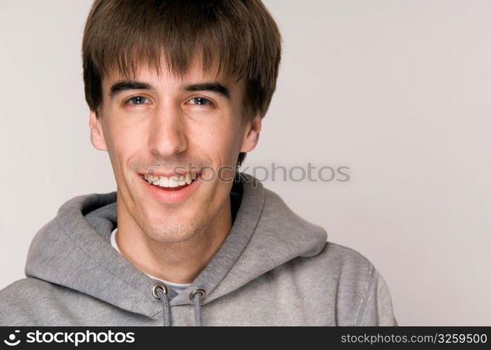 Young male wearing hooded sweatshirt.