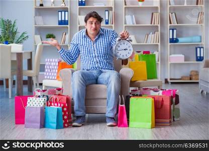 Young man after excessive shopping at home