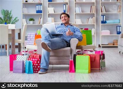 Young man after excessive shopping at home