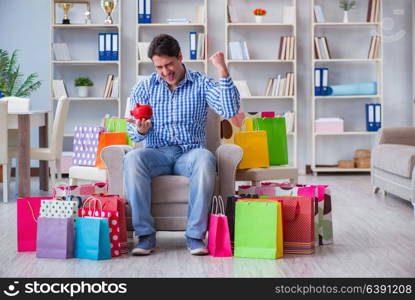 Young man after excessive shopping at home