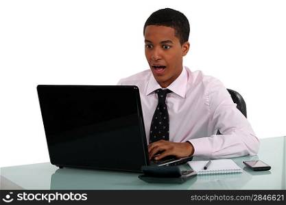 Young man aghast at his computer