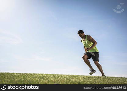 Young man agility running on park hill