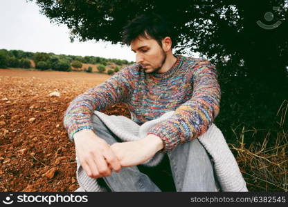 Young man alone and sad in nature